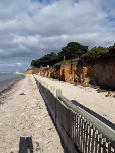 a shadow of a person standing on the beach at Bay Bell Cottage in Saint Leonards