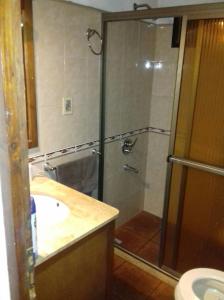 a bathroom with a shower and a sink at las cuatro eme in Paysandú +17 photos