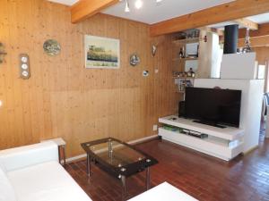 a living room with a flat screen tv on a wall at Las Bargias 8 (472 Me) in Lenzerheide