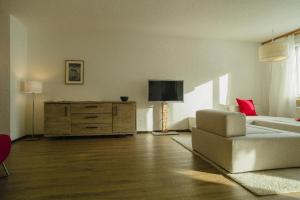 a living room with a couch and a dresser at Seestrasse 1 (292Ap) in Lenzerheide