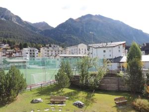 a city with a tennis court with mountains in the background at Allod (166 Da) Whg. Nr. 103 in Lenzerheide