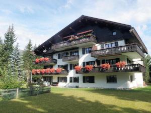 a large building with flower boxes on the balconies at Helvetia (388 Sr) 2. Stock in Lenzerheide