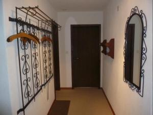 a hallway with a black door and a mirror at Bella Val (206 Se) in Lenzerheide