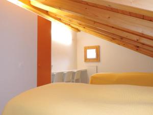 a room with a bed with chairs and a window at Gloria C4 (276 Rc) in Lenzerheide