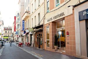 an empty city street with shops and buildings at L'Esterel in Cannes