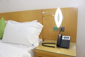 Ένα ή περισσότερα κρεβάτια σε δωμάτιο στο Paradisia Hotel