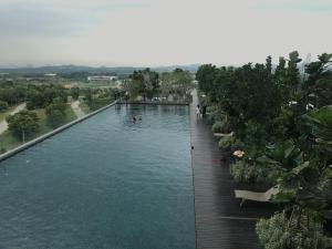 a swimming pool with people in the water at CBD3 SOHO in Cyberjaya