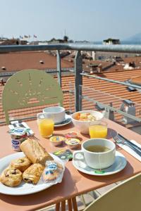 a table with plates of food and cups of coffee at L'Esterel in Cannes