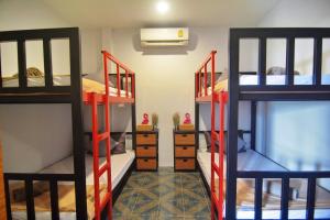 a room with three bunk beds in a room at Lanta Hostel in Ko Lanta