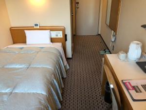 Postel nebo postele na pokoji v ubytování Hotel Hikari Hills