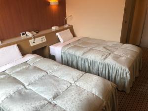 Postel nebo postele na pokoji v ubytování Hotel Hikari Hills