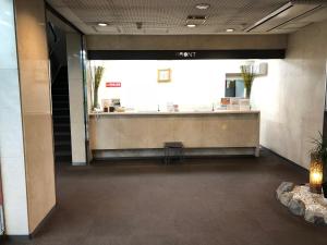 a lobby with a reception desk in a building at Hotel Hikari Hills in Shunan