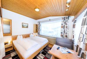 a bedroom with a large window and a bed at Appartements Haus Sonnenschein in Zell am See
