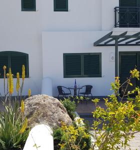 a patio with a rock and a table and an umbrella at Casa Maria en Agaete in Agaete