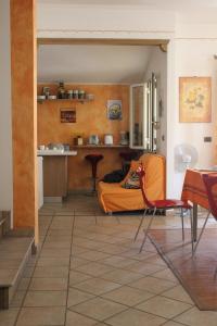 a living room with a couch and a table and chairs at B&B S'arenada in Ghilarza