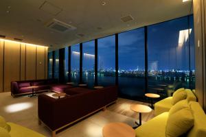 a living room with a view of a city at THE SINGULARI HOTEL & SKYSPA at UNIVERSAL STUDIOS JAPAN in Osaka