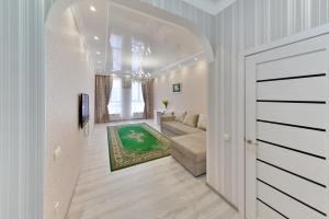 pasillo que conduce a una sala de estar con sofá en Apartments LUX 53/144, en Astana