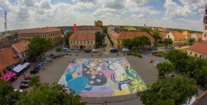 a large parking lot with a large painting on it at Ergzotic Apartments & Room in Sombor