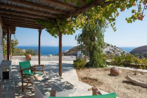 a patio with a table and chairs and the ocean at Agnanti Traditional in Kastron