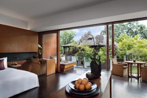 a bedroom with a bed and a large glass window at Anantara Chiang Mai Resort in Chiang Mai +37 photos