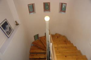 a staircase in a house with a light on the wall at Dacha u Morya Bugaz in Gribovka