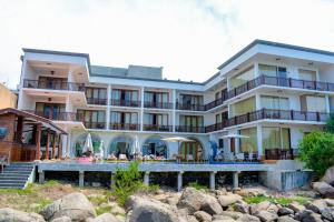 a hotel on the beach with rocks in front of it at Watergate Resort Unawatuna in Unawatuna