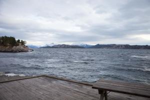 
a wooden dock with a view of the ocean at Florø Rorbu in Florø
