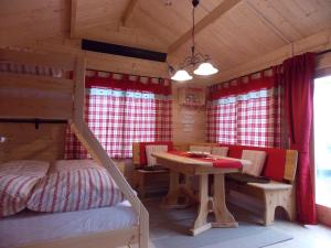 a bedroom with a bed and a table in a cabin at Weiherhütte in Glan-Münchweiler