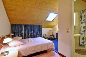 a bedroom with a bed and a skylight at San Rocco Apartment in Corfu