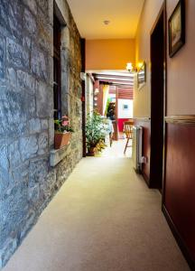 a hallway of a house with a stone wall at Clarke Cottage Guest House in Dunfermline