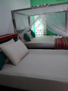 Postel nebo postele na pokoji v ubytování Akurala Beach Park