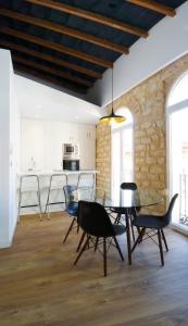 a dining room with a glass table and chairs at Alicante old city & beach appartment in Alicante