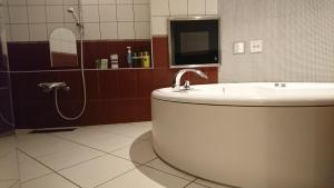 a bathroom with a tub and a sink and a shower at Hotel Shindbad Aomori -Love Hotel- in Aomori +9 photos