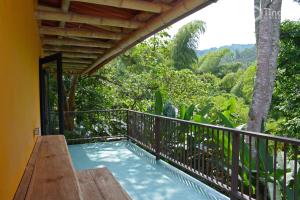 a balcony of a house with a swimming pool at Tinamu Birding in La Manuelita