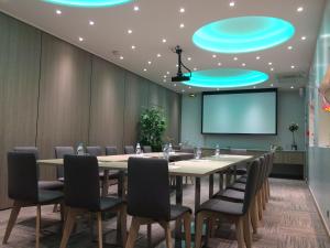 a conference room with a table and chairs and a projection screen at Best Western Hôtel De France in Chinon