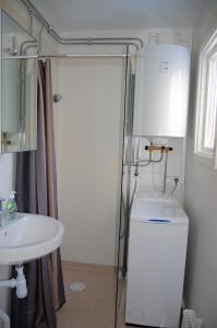 a bathroom with a shower and a toilet and a sink at Lilla Solhaga in Ljungskile