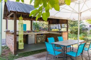 an outdoor kitchen with a table and chairs at BigBlue house in Veli Lošinj