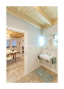 a bathroom with a sink and a table at Pröser Mühle in Weilmünster