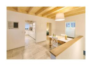 a kitchen and a dining room with a table in a room at Pröser Mühle in Weilmünster