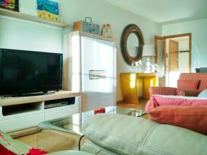 a living room with a flat screen tv and a couch at Gran Plaza in Roquetas de Mar