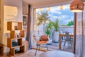 Zimmer mit einem Balkon mit einem Stuhl und einem Tisch in der Unterkunft Truchet Penthouse in Arles