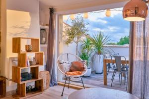 a room with a balcony with a chair and a table at Truchet Penthouse in Arles