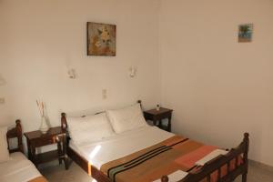 a bedroom with a bed and two night stands at Rent Rooms Katerina in Kalamaki Heraklion