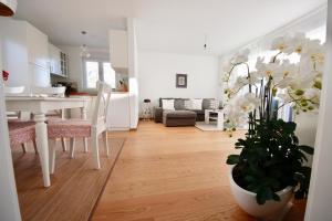 a kitchen and living room with a table and a dining room at Villa More in Makarska