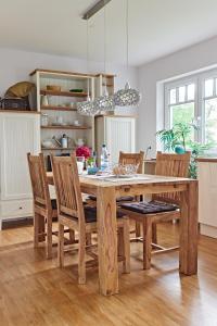 a dining room with a wooden table and chairs at Eichenlodge in Apensen