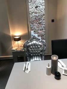 a table with a chair and a table cloth on it at Hotel Lindenhof in Düsseldorf