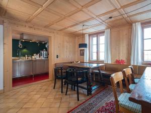 a kitchen and dining room with a table and chairs at Waelderhus Tamegger in Krumbach