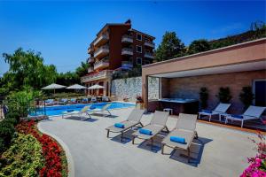 a patio with lounge chairs and a swimming pool at Villa Sea Breeze in Split