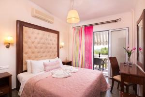 a hotel room with a bed and a desk and a window at San Antonio Beach Apartments in Potos