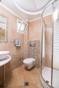 a bathroom with a shower and a toilet and a sink at San Antonio Beach Apartments in Potos +33 photos